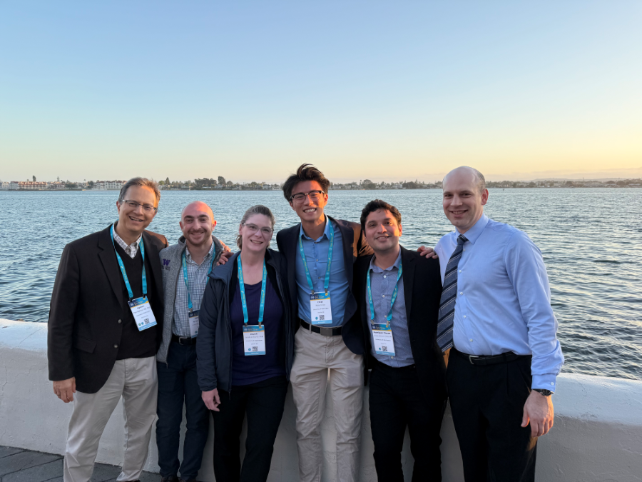 Faculty and trainees posing by ocean 