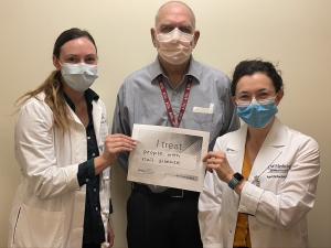Caitlin Crimp, MD, Phil Fleckman, MD, April Schachtel, MD, holding a sign sayig "I treat people with nail disease."