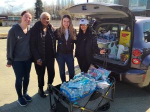 Erin McClure and Neha Singh, Nghiem Lab Fellow, deliver hygiene kits made from donations to the skin health donation drive.