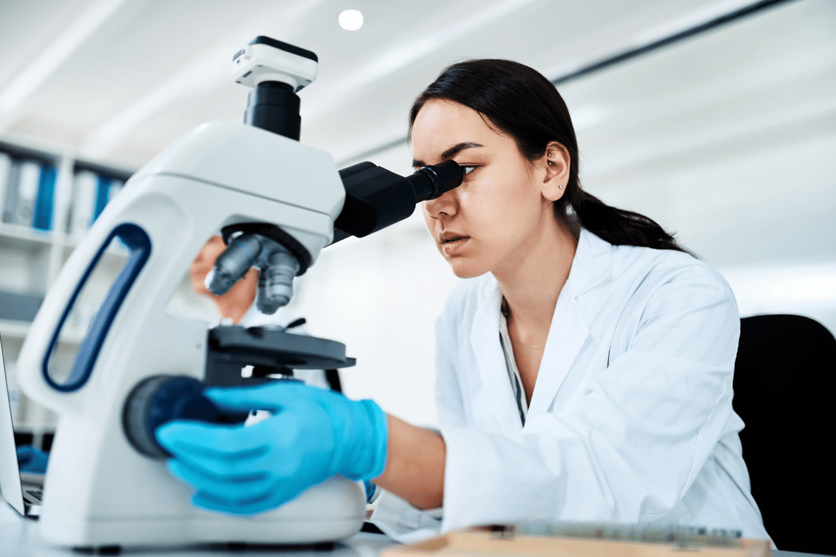 Medical researcher looking in a microscope