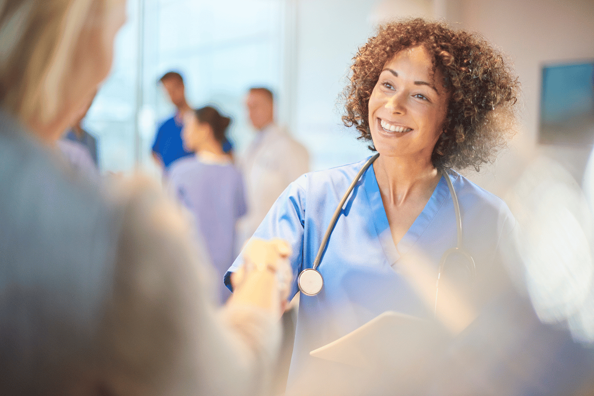 a nurse smiling at a coworker