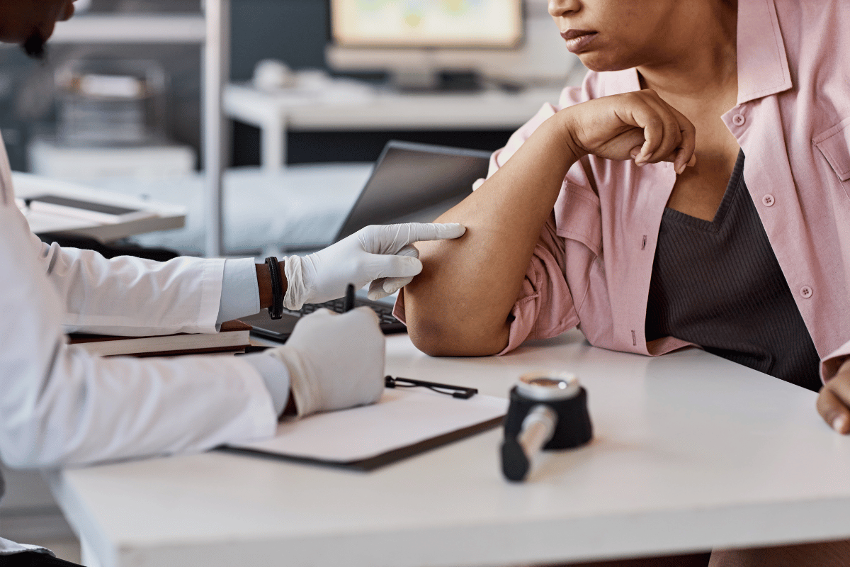 doctor examining a patients arm