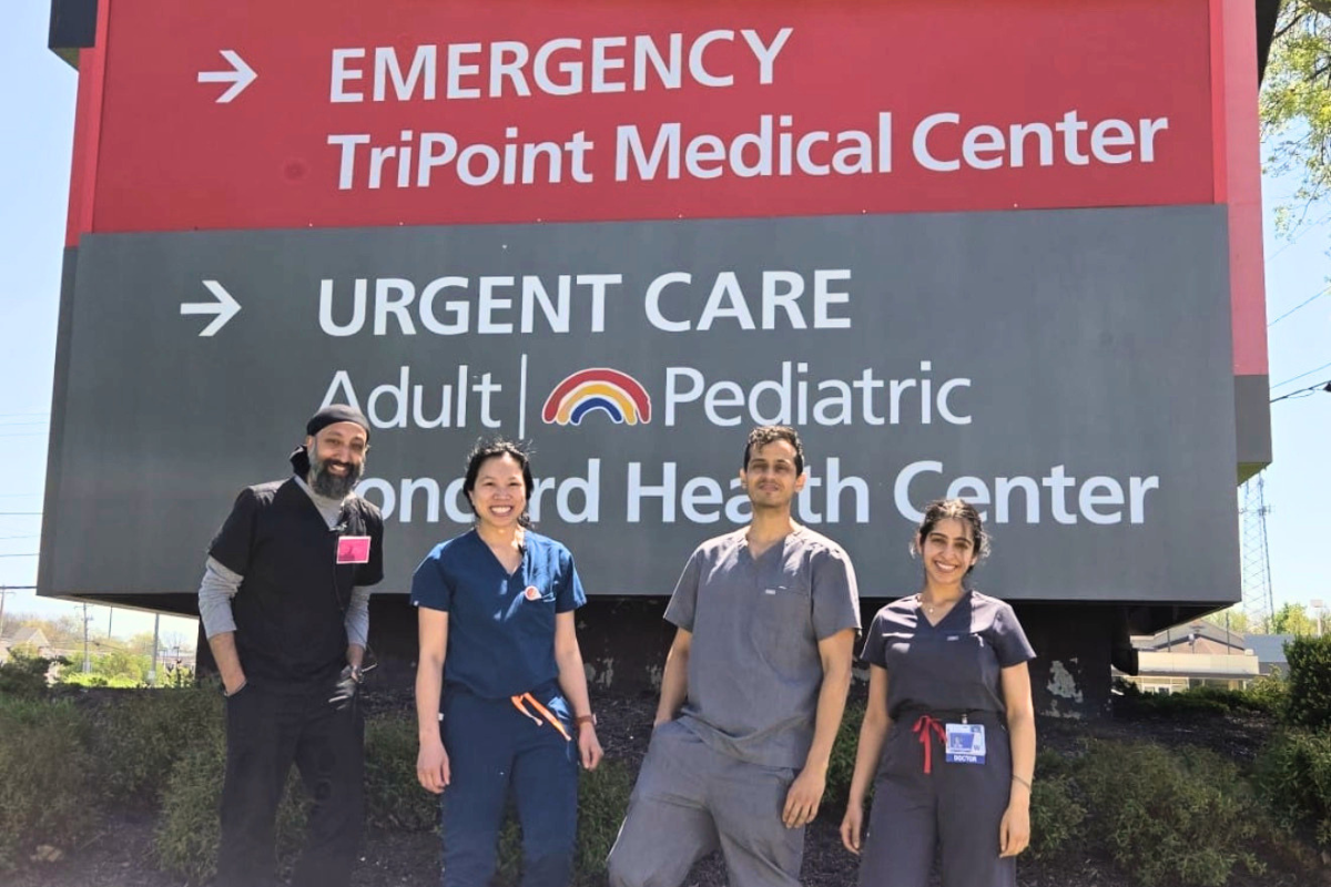 Ashi Gautam infront of University Hospitals sign with colleagues