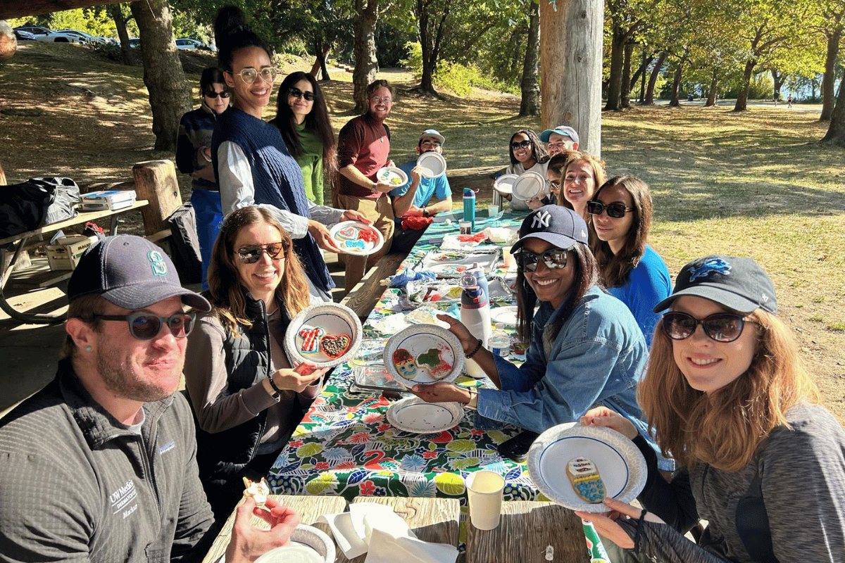Derm residents around a table decorating cookies