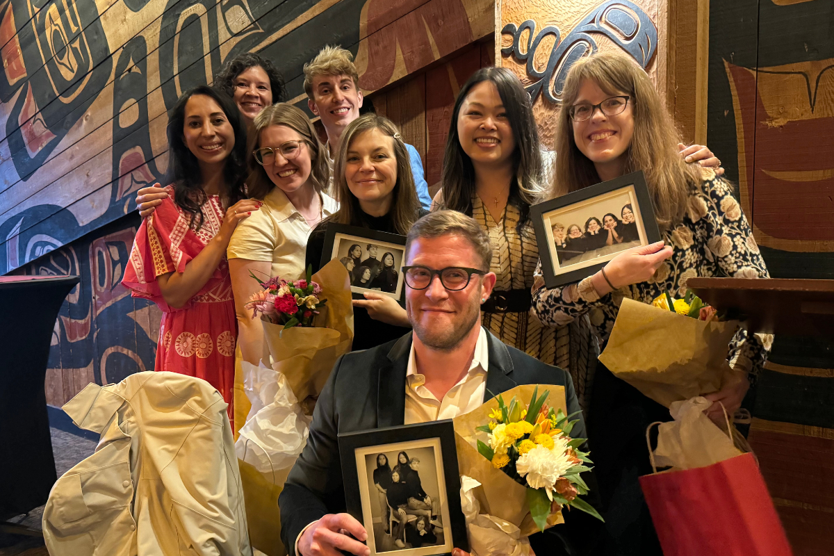 Residents and faculty holding up a framed photo