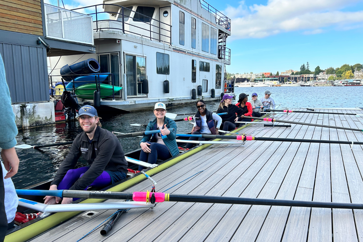 People in a rowing boat at the dock