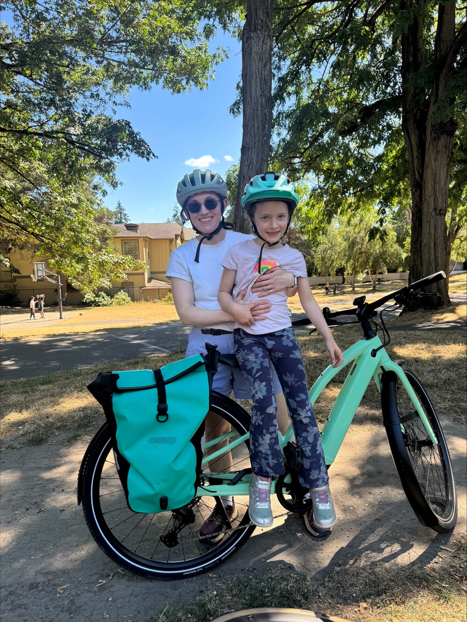 A woman with a little girl in front of a bike