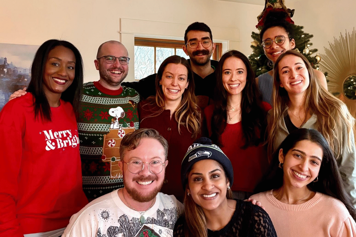 residents standing in front of a holiday tree