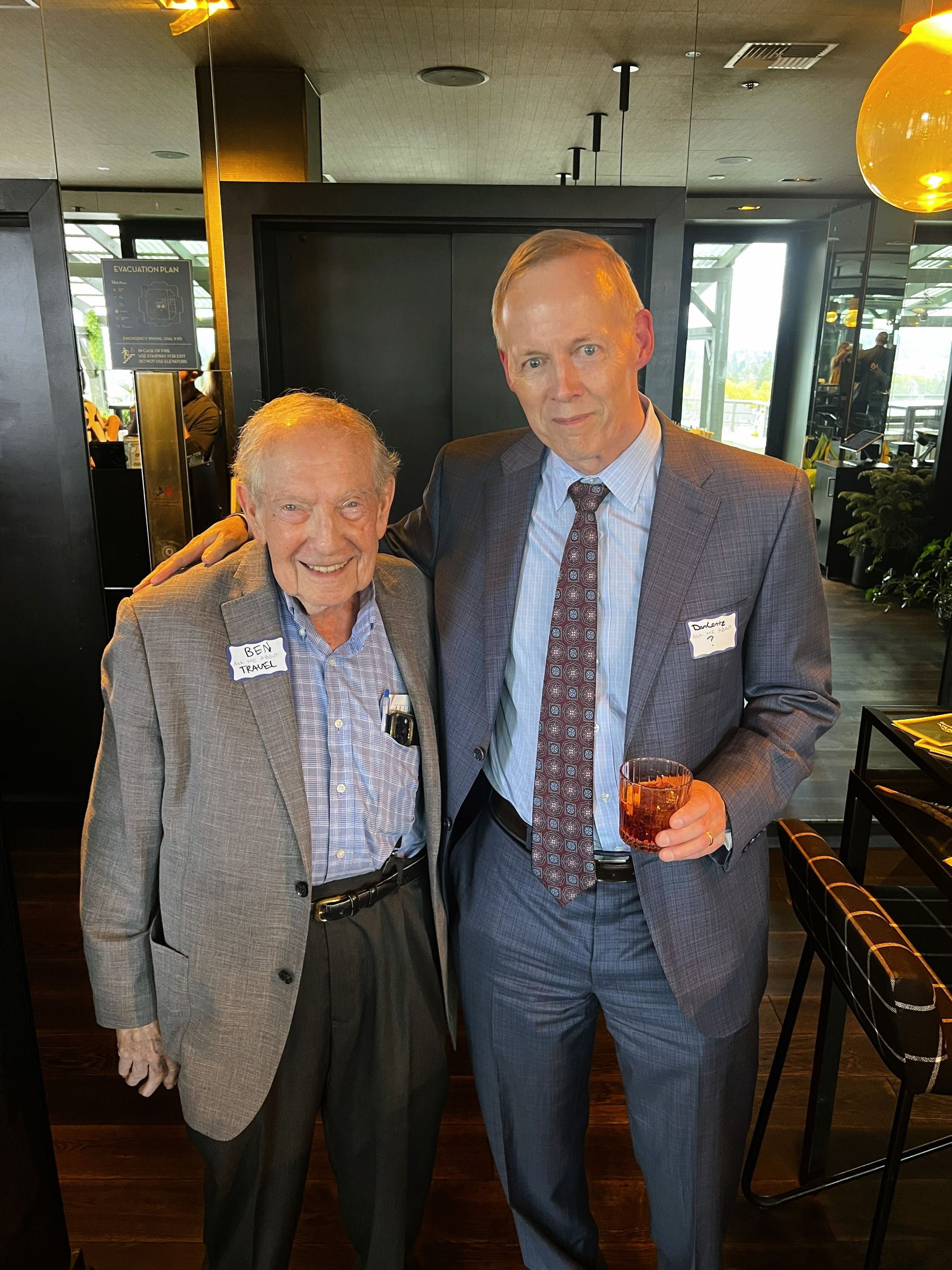 Two men in suits smiling